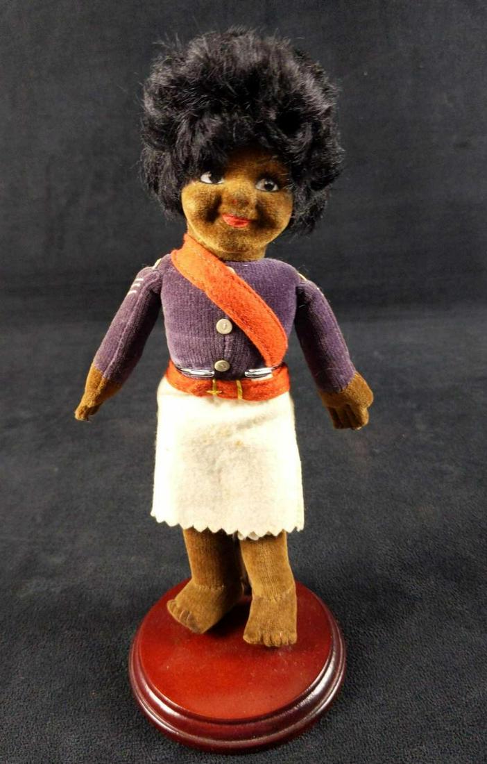 Vintage Norah Wellings Black Velveteen Doll: Vintage Norah Wellings Black Velveteen Doll. This one is dressed as a 'Tonga police sergeant' and comes with a stand. Doll is approx 3 1/2" x 3 1/2" x 10". Dol is in good, vintage condition with some