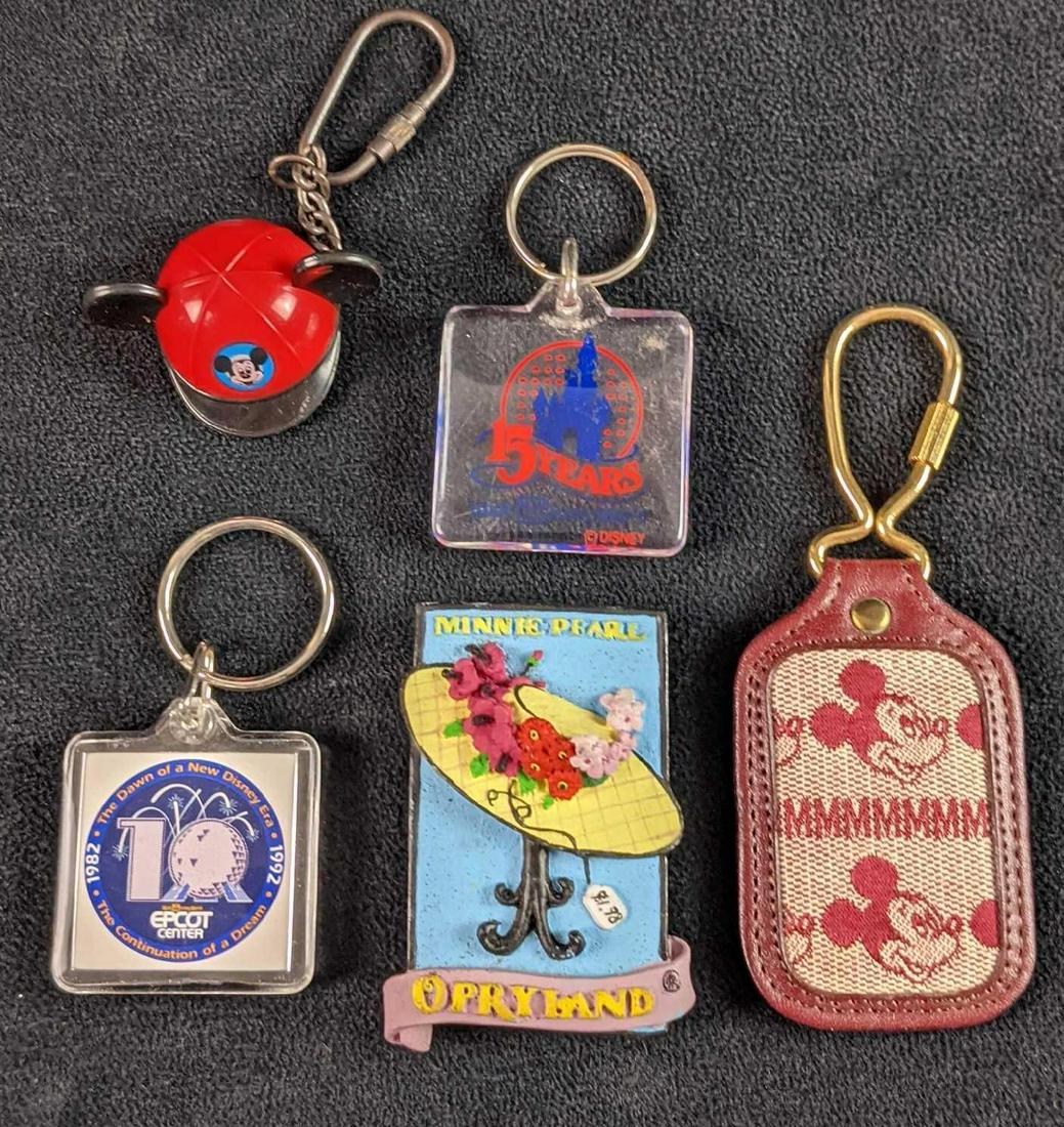 Five Souvenir Disney Epcot Mickey Mouse Minnie Pearl: This lot includes: (1) Mickey Mouse "Mmmm". Full Grain Cowhide Keyring. (1) 15th Anniversary Walt Disney World Keyring. (1) 10th Anniversary Epcot Keyring. (1) Mickey Mouse Baseball Hat With Ears Keyr
