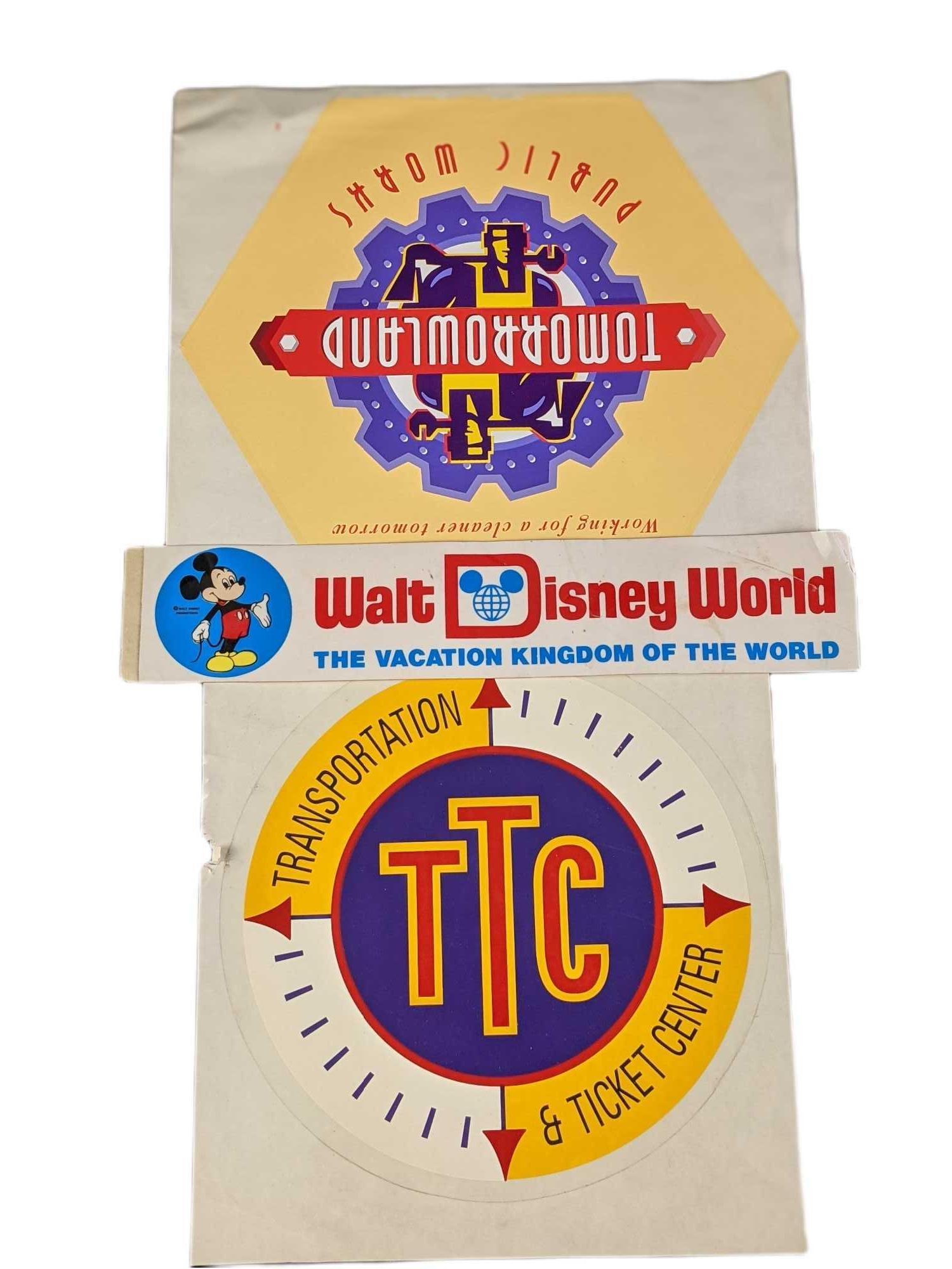 Three Disney Decal Bumper Stickers Mickey Tomorrowland: This lot includes: (1) Vintage Walt Disney World Bumper Sticker With Mickey. (1) Tomorrowland: Working For A Cleaner Tomorrow Decal, (1) Walt Disney World: Ticket And Transportation Decal. All sticker