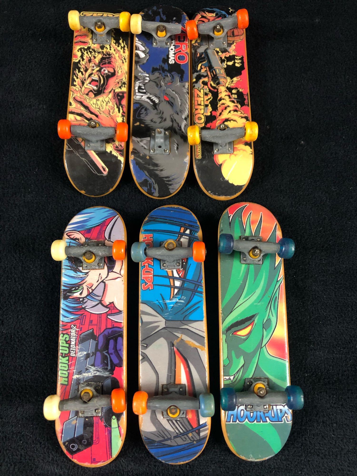 Lot Of Six Tech Deck Zero's & Hookup Finger Skate: Lot Of Six Tech Deck Zero's & Hookup Finger Skate Boards.This lot includes three Zero Boards and three Hookup boards all in good condition with scuffs one missing a set of trux and wheel . please take
