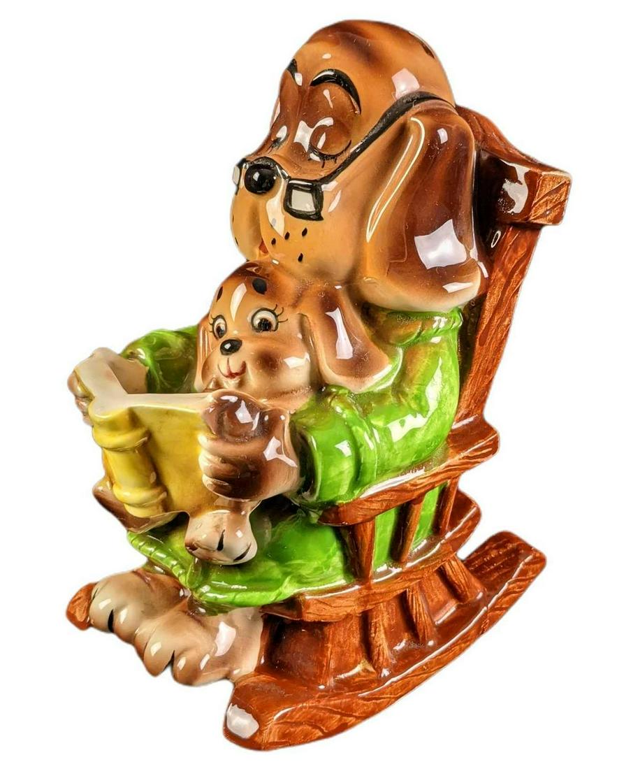 Vintage Ceramic Doggy Dad And Son Rocking Chair Bank: Here is a rather absorbable vintage piggy bank of a dog-dad on a rocking chair with his son (or daughter) who he reads to. The maker and date of creation are unknown. the bank is approx 4" x 5" x 7 1/