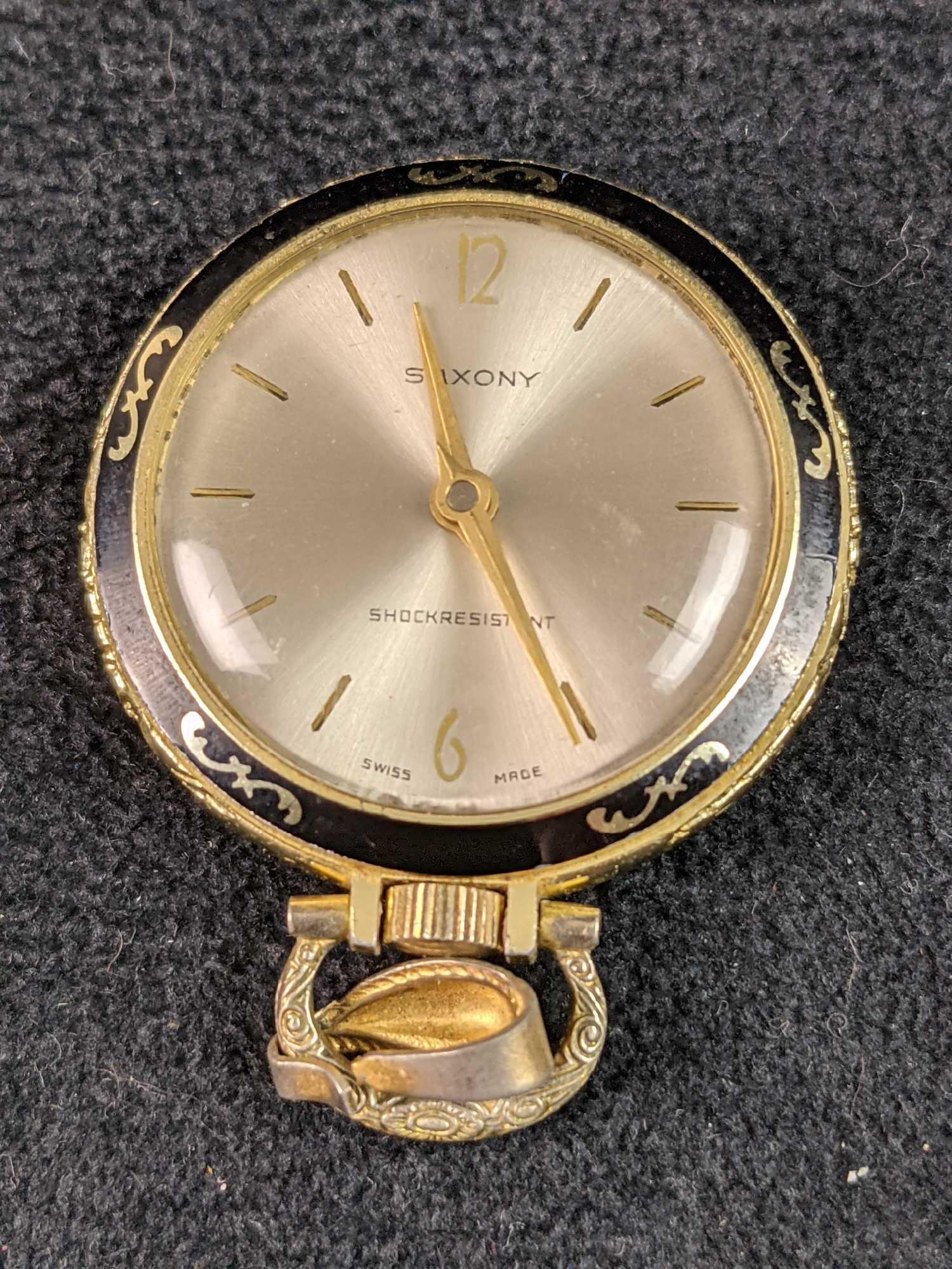 Vintage Gold Plate Swiss Saxony Lady's Pocket Watch: Vintage Gold Plate Swiss Saxony Lady's Pocket Watch. Wind Up. All our jewelry is tested and researched prior to posting. Please view all our pictures they are part of our description. DETAILS : Metal