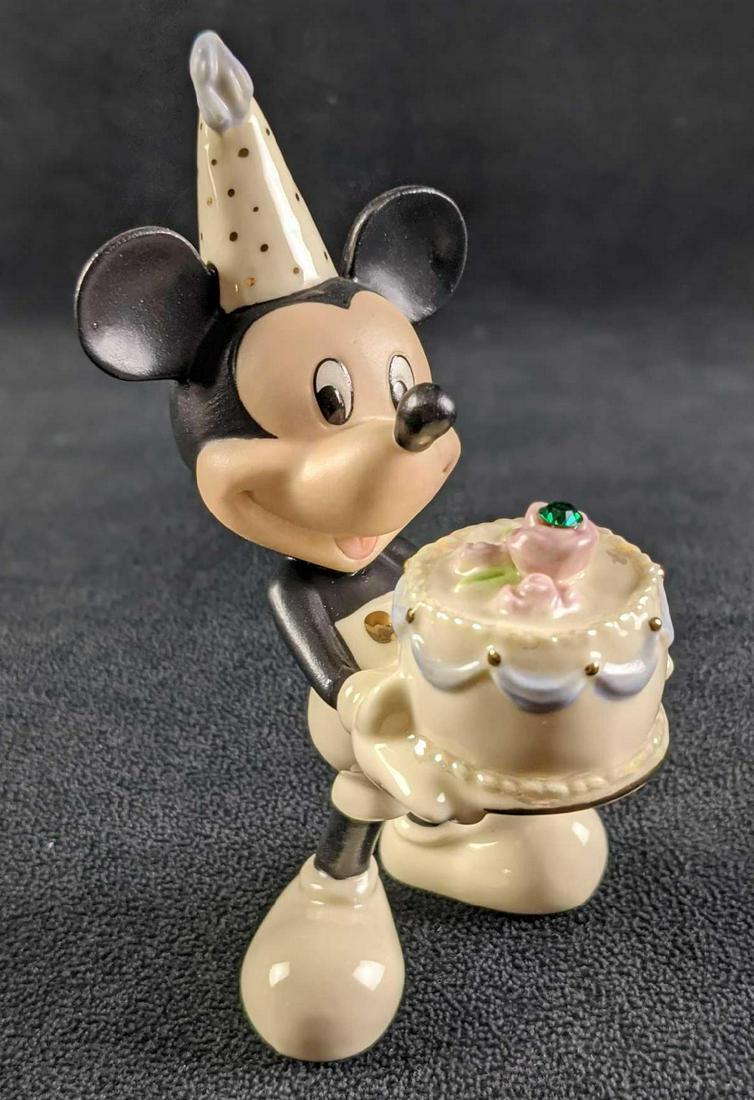 Retired Mickey's Happy Birthday To You By Lenox: Retired Mickey's Happy Birthday To You By Lenox Figurine. Was released from 2005-2021. Has an imitation emerald for May. Made of fine china. Is approx 3" x 1 1/2" x 5" and weighs under one pound at 0.