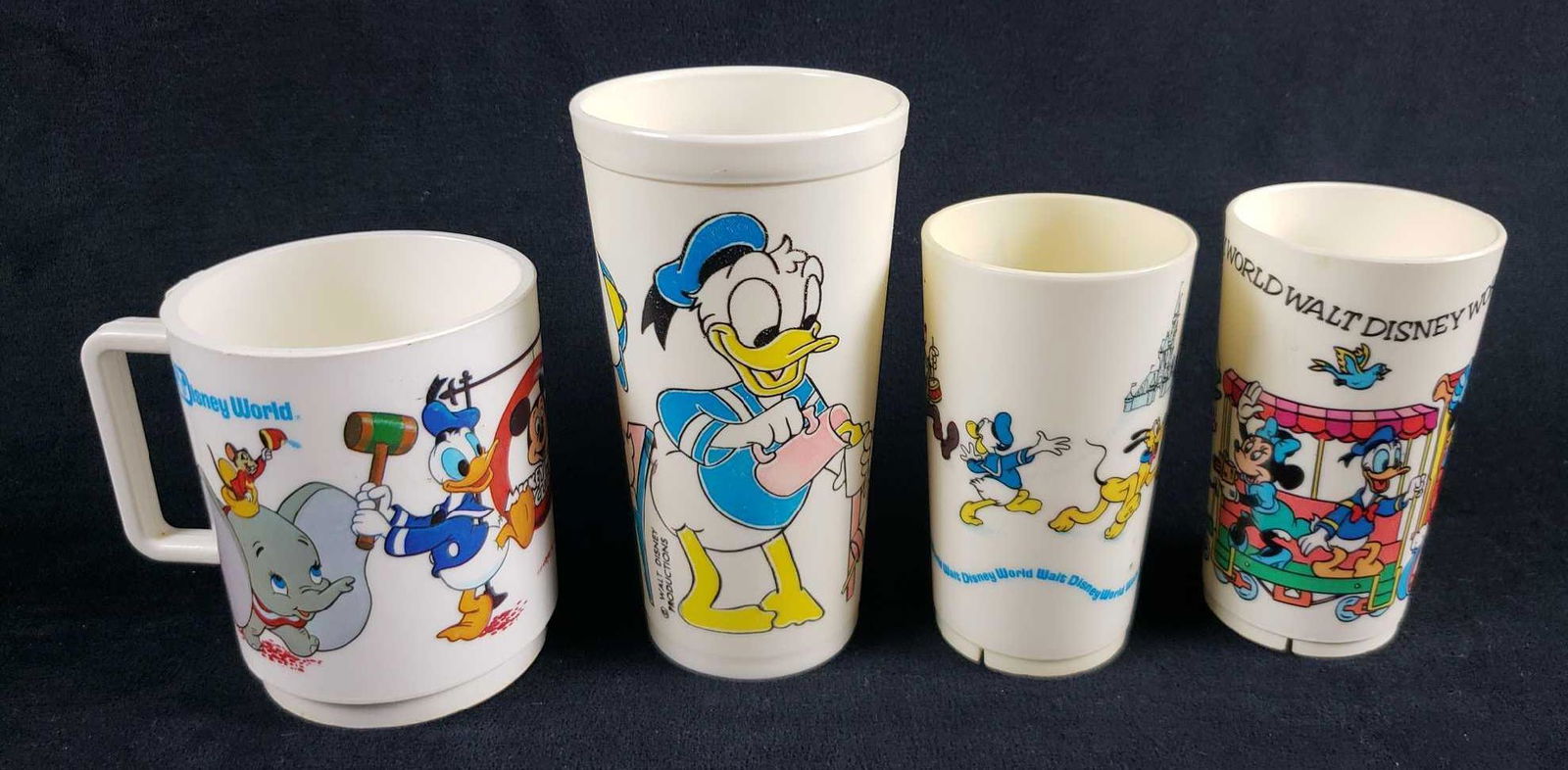 Lot of 4 Plastic Walt Disney Productions Pre 1986: Lot of 4 Plastic Walt Disney Productions Pre 1986 Plastic Cups Mugs. This lot of plastic mugs and cups is in overall good to fair condition. The items have some signs of discoloration, such as yellowi