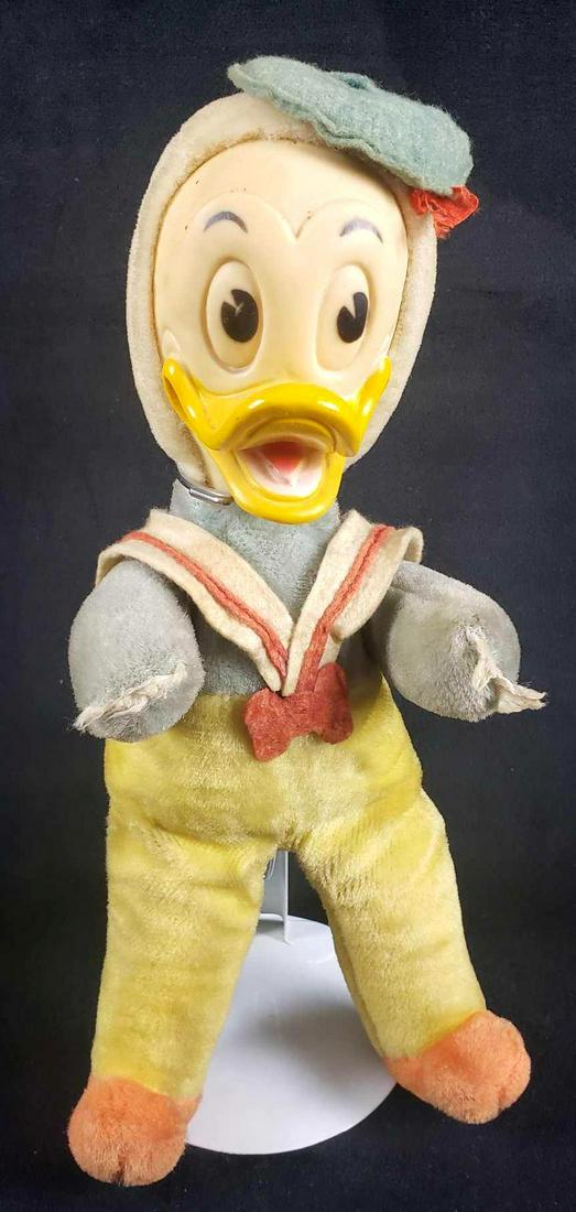 Walt Disney Productions Woolkin Original Stuffed Donald: Walt Disney Productions Woolkin Original Stuffed Donald Duck Toy on Display Stand. This Donald Duck stuffed toy is in fair to good used condition. The stuffed toy shows signs of discoloration to the f