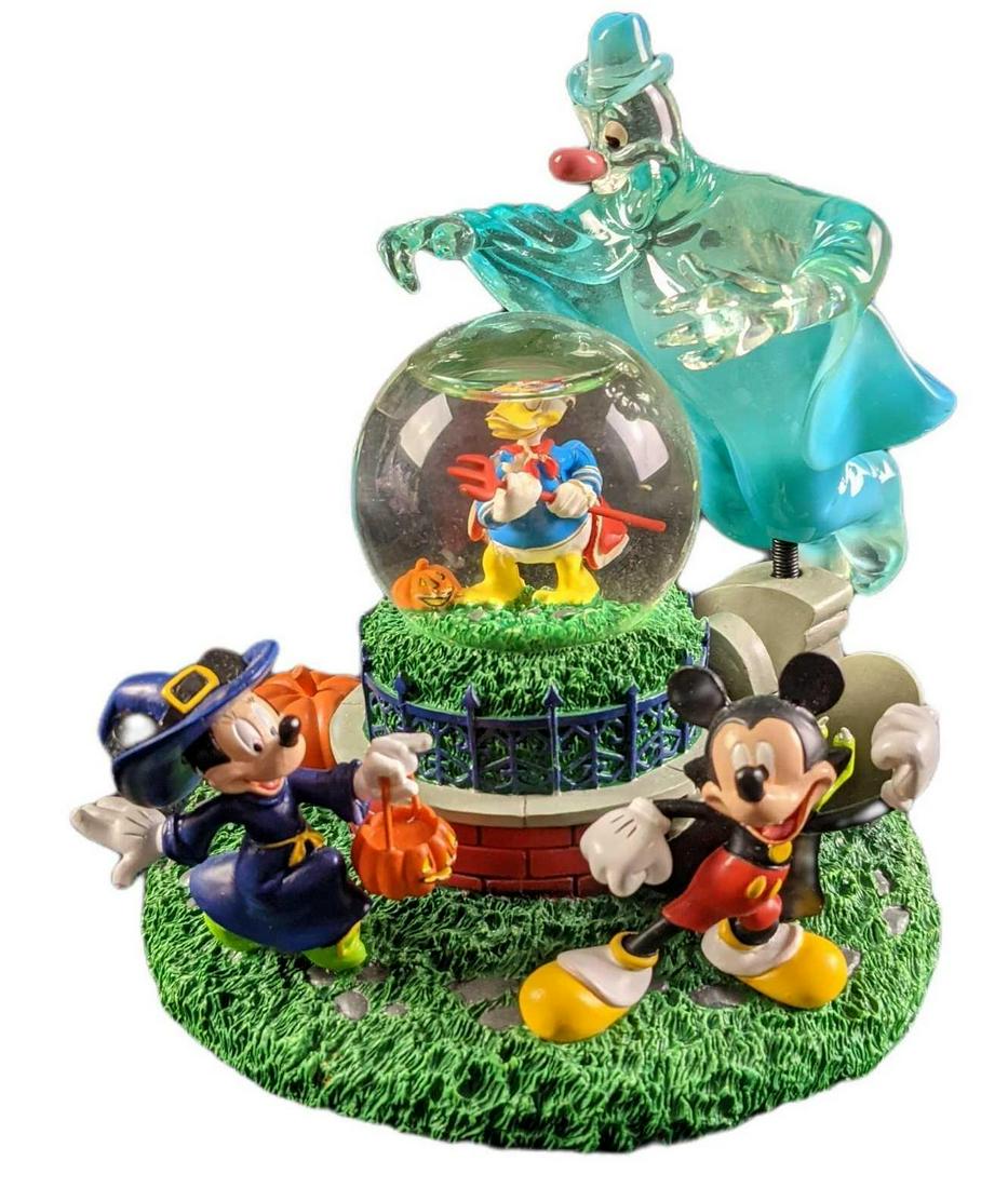 Disney Lonesome Ghost Halloween Snowglobe: Disney Lonesome Ghost Halloween Snowglobe. Made of resin. Mickey and Minnie Mouse do a little trick or treating, while poor Donald is bedeviled by one of the ''Lonesome Ghosts". Is approx 5" x 5" x 5"