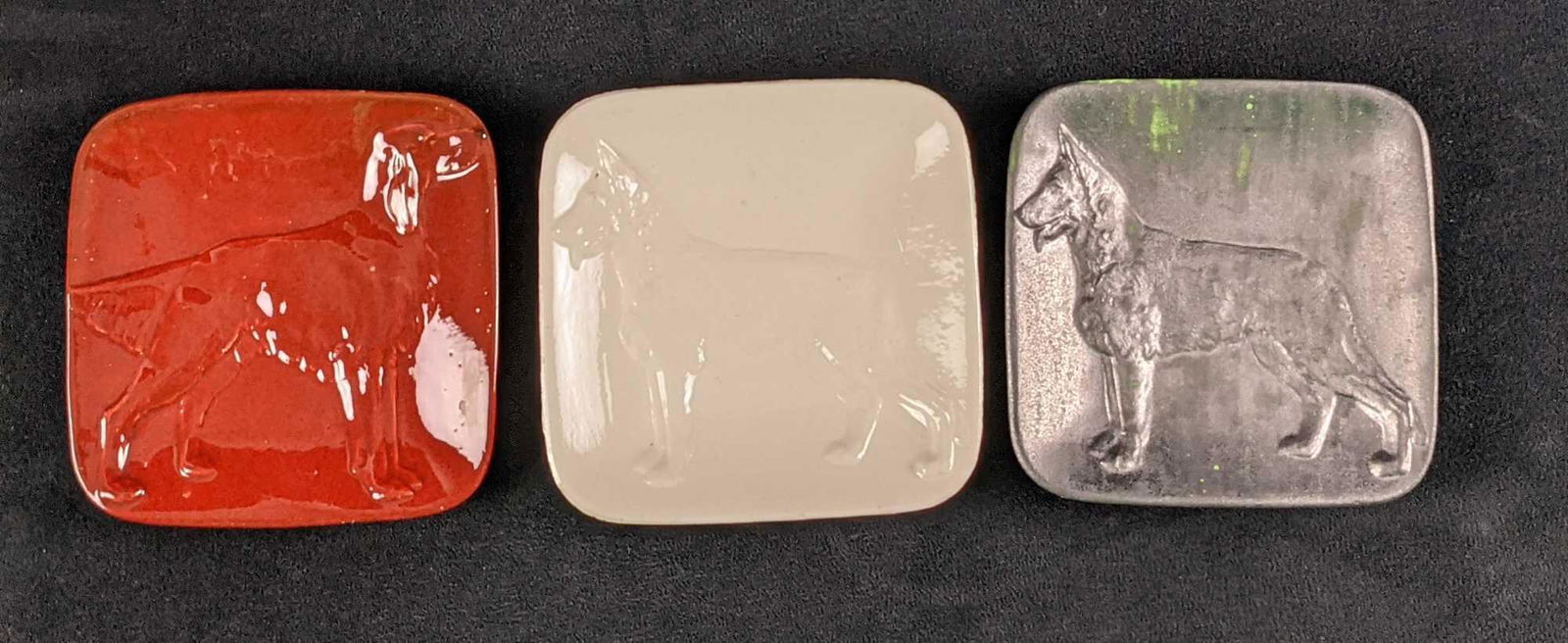 Three Vintage Kay Finch Dog Plates: Kay Finch created many dog figures that were modeled after American Kennel Club Champions. This lot includes three different color plates. Made in California during the 1940s and 1950s. Plates are app