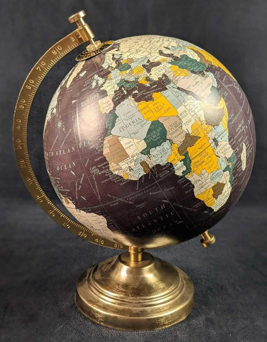 Designco Table Desk World Globe A: Designco Table Desk World Globe With Brass Colored Metal Stand. Is approx 9" x 8" x 12" and is in a good, used condition with some light wear. The area near Russia/Alaska is not lined up properly.
