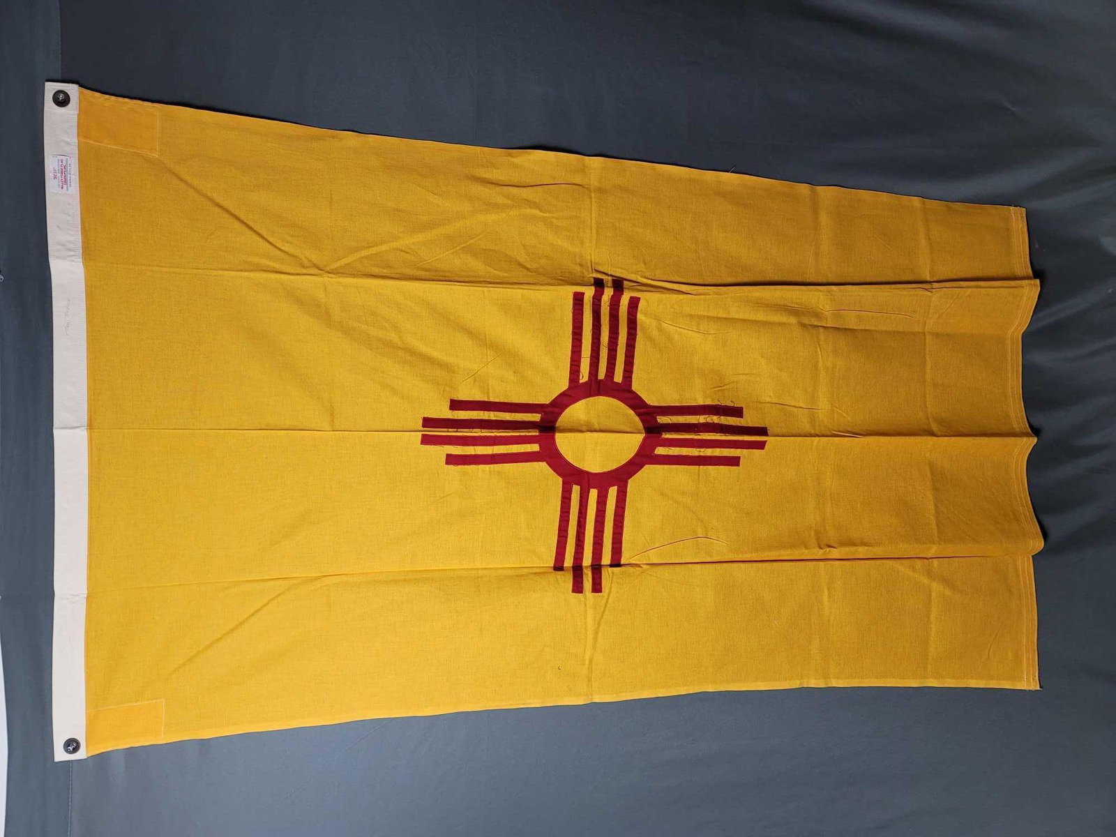 New Mexico Cotton State Flag: New Mexico cotton fabric state flag. Made by Valley Forge Flag Company PA. Flag in good condition. Approx. measures 58"x 34"