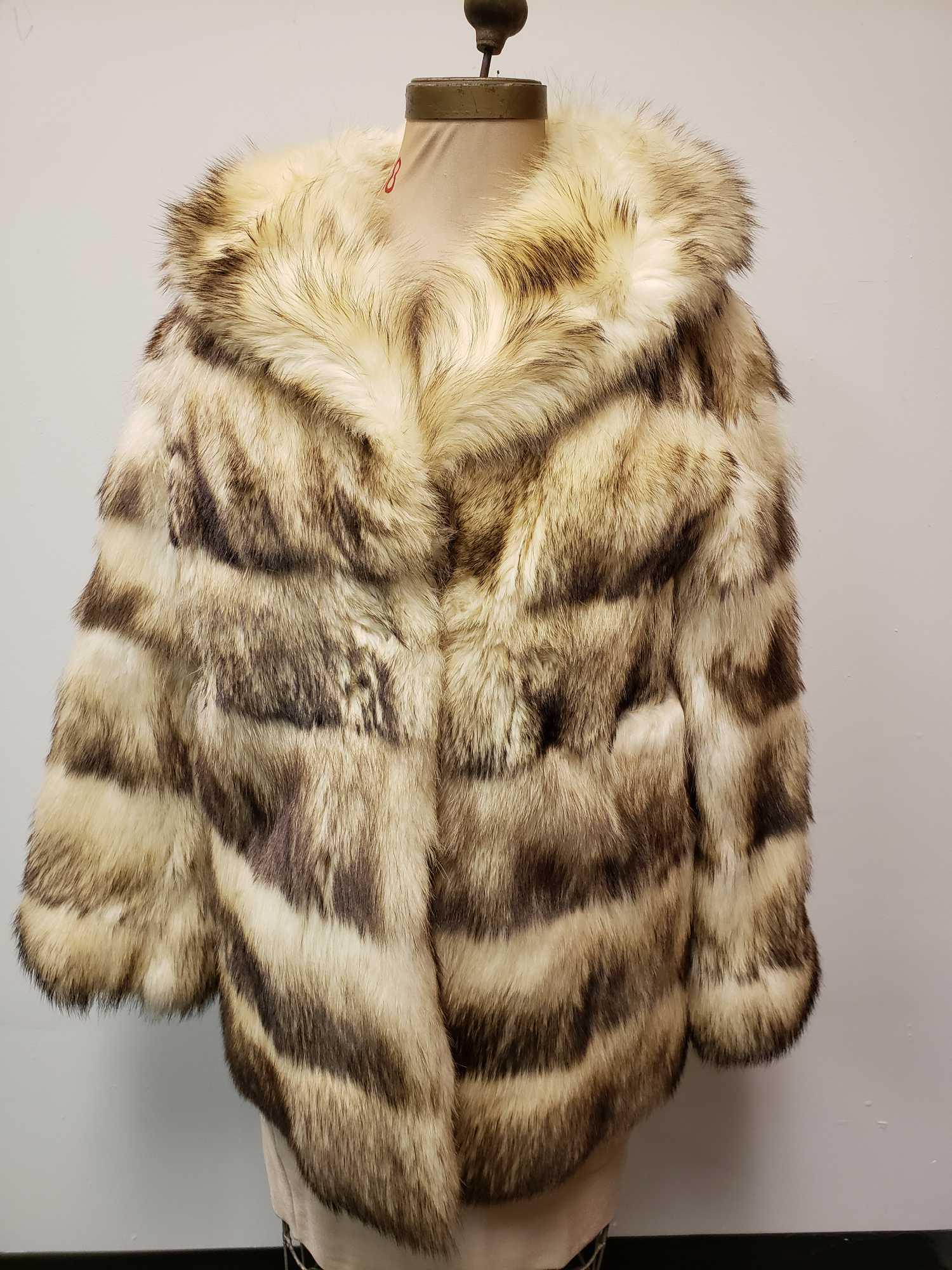 Designer Renee Fitch Fur Coat: Designer Renee Fitch Fur Coat. This fitch fur coat is in fair used condition. The coat's right shoulder has about a 1" tear in the seam (see images). The coat has a tan colored lining with a hook and 