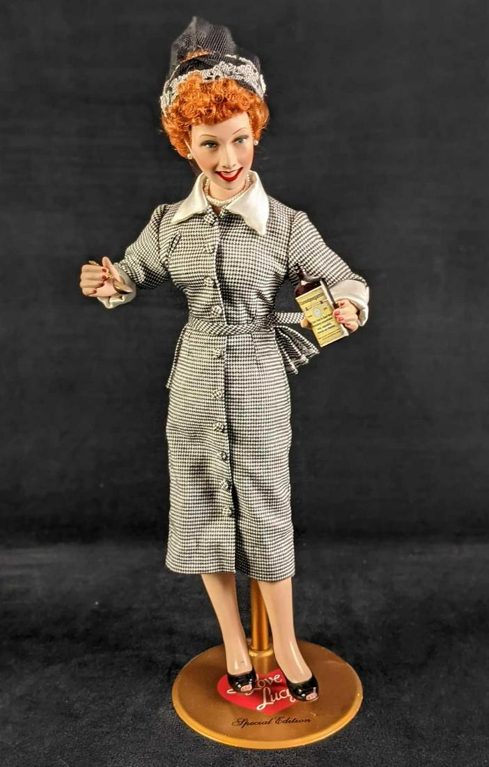 I Love Lucy Vitameatavegamin Anniversary Edition Doll: I Love Lucy Vitameatavegamin Anniversary Edition Doll. With a porcelain head, neck, arms, hands, legs and feet. Comes with the stand seen in the images. Doll with stand is approx 5" x 5" x 16". Doll i