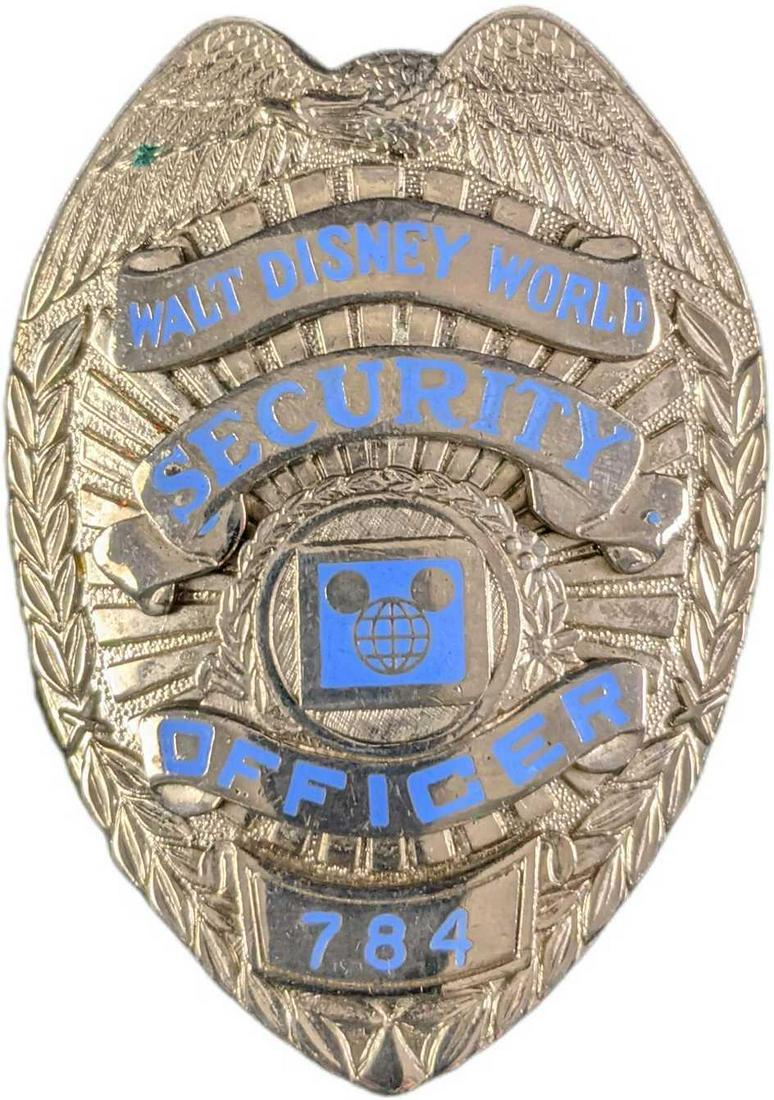 1970/1980s Disney World Security Metal Badge: 1970/1980s Disney World Security Metal Badge. Is approx 2" x 1" x 3" and it weighs under one pound at 0.16lb. The metal badge is in a good, vintage condition some markings on the eagle and on the "S" 