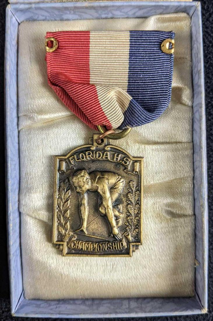 1940s Florida H.S. Championship Running Medal: 1940s Florida H.S. Championship Running Medal 1940s 3rd Place Sprint Medley Relay Florida H.S. Championship Medal pin. It comes in its original box pined to a small cushion. Box pin is in is 3.5in x 2