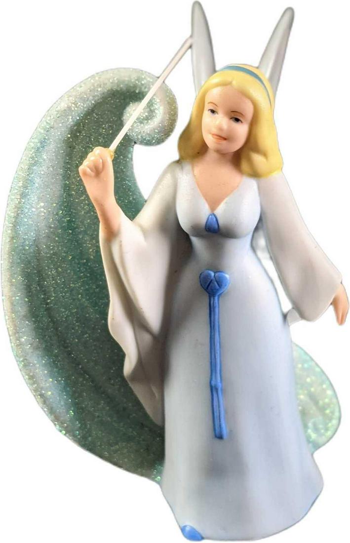 Disney Blue Fairy Godmother Porcelain Figurine: Vintage porcelain Disney Blue Fairy Godmother from Pinocchio figurine. She is just gorgeous with a blue glitter swirl trail from her wand and iridescent porcelain wings. Is approx 3" x 2" x 4 3/4" and