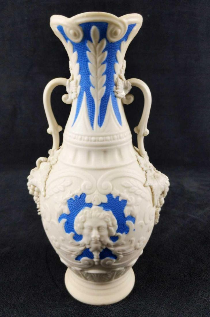 Vintage Bennington Blue And White Parian Ware Vase: Bennington Blue And White Parian Ware Vase. The vintage vase shows the visage of Dionysus, the Greek god of wine, along with grapes on the sides. These are all heavily textured. Vase is approx 5" x 4"