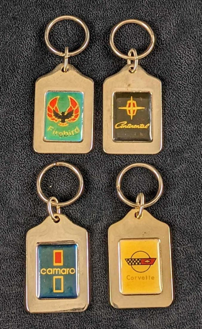 Epcot World Of Motion GM Car Keychains: Here are four metal keychains all with different GM brands. There is Continental, Camaro, FireBird, and Corvette. These were originally sold at the "World Of Motion" pavilion at the Epcot Center in Or