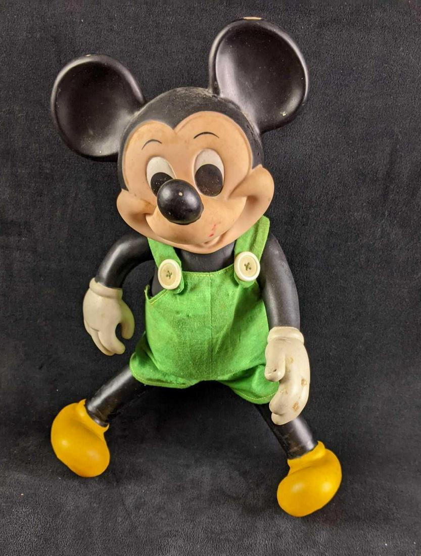Vintage Mickey Mouse Baby Doll: Vintage Mickey Mouse Baby Doll This Mickey Mouse baby doll wears green overalls. This Mickey has some discoloration/paint loss from age but is in good condition with moveable limbs and head. Approx me