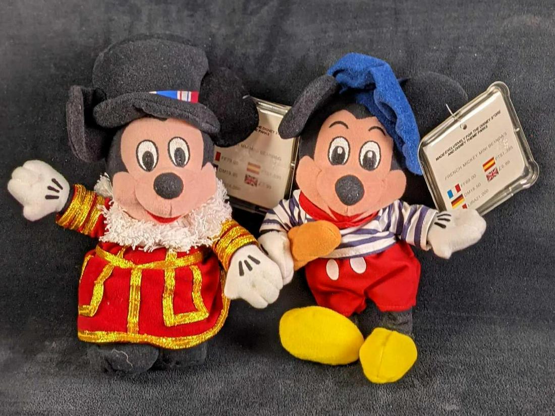 Two Disney Bean Bag Dolls British French Mickey: This lot includes Disney Bean Bag Dolls exclusive to the Disney Stores in the UK. This includes: (1) Mickey English Beefeater Guard. (1) French Mickey. Both bean bag dolls come in a protective acyclic