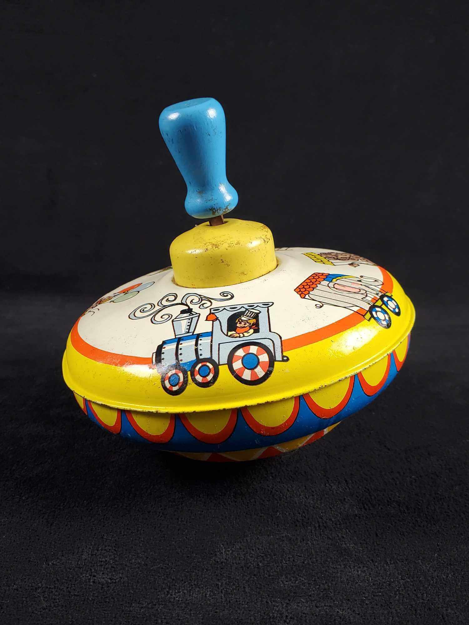 Vintage Ohio Art Metal Top Spinner: This vintage Ohio metal top spinner depicts circus animals. From the 1940's to 1950's and is in working vintage condition with some rust and dents. Very neat find. Measures approx 5 1/2" x 5 1/2" x 5"