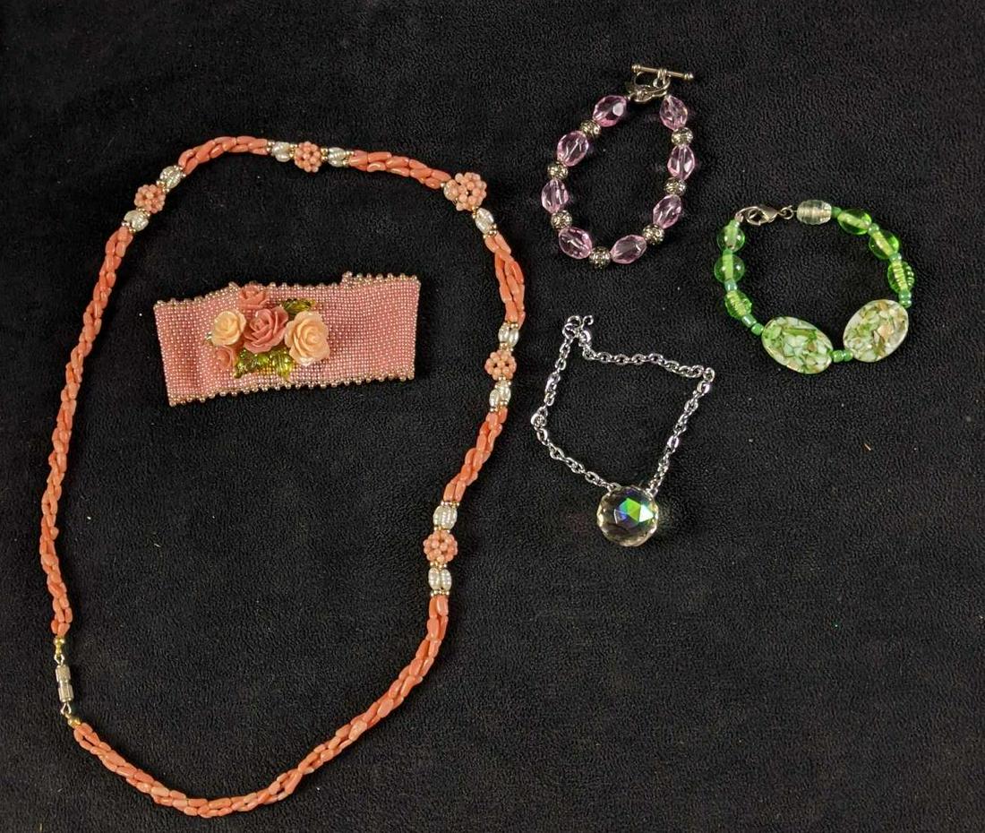 Assorted Pink Flower Themed Jewelry: Assorted Pink Flower Themed Jewelry This is a pretty set of jewelry with some bracelets with glass beads or even some river pearls. They are used but in good condition. It is a great assortment of jew