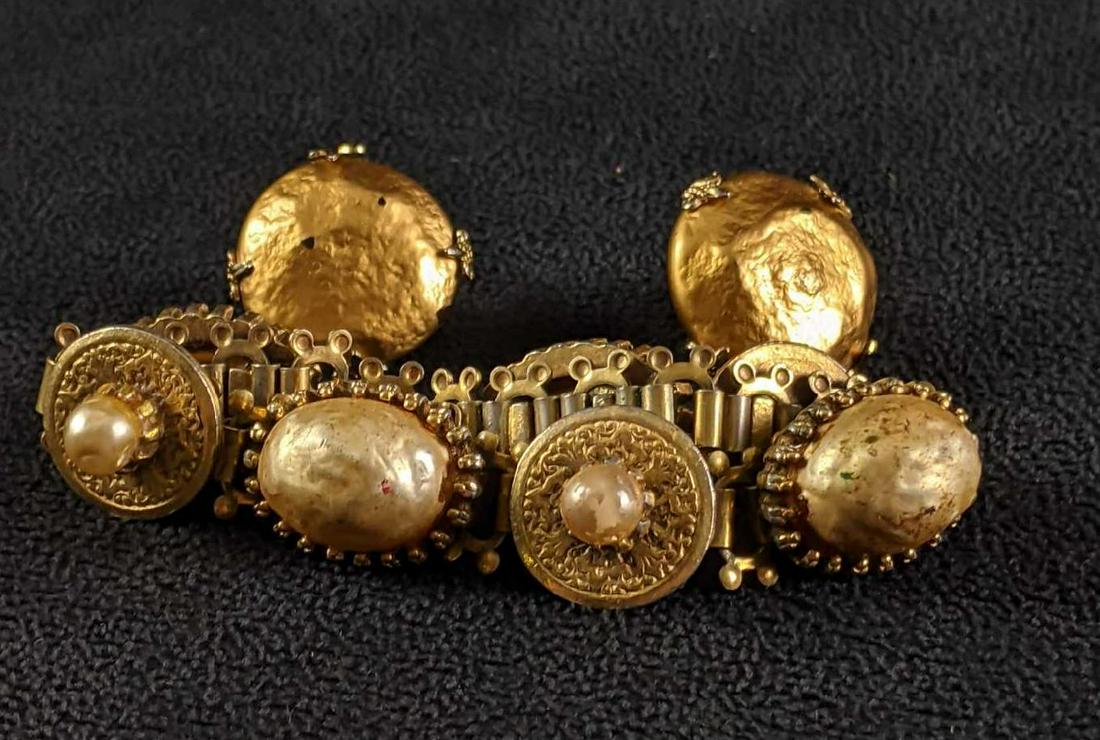 Bracelet and Clip-on Earring Set: Bracelet and Clip-on Earring Set This set is gold-colored with a bracelet and earrings used the earrings have some black stops that are tiny chips. Otherwise, these are in great condition