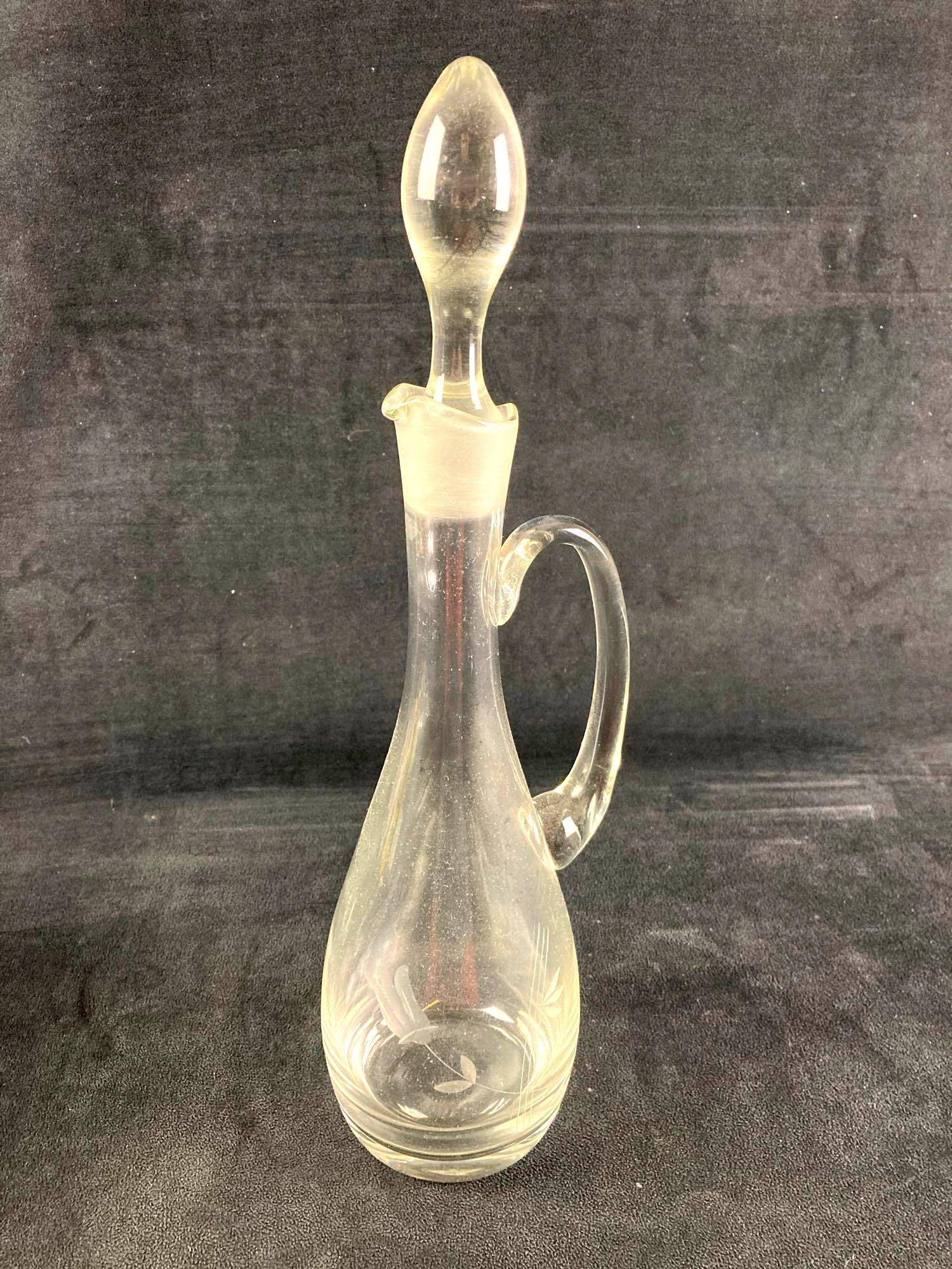 Old Glass Wine Vase: Old glass wine vase fresh from recent estate. Has flower decorations along the front and a bottle topper. This auction includes: (1) Wine Vase Glass with Flower Design Condition is considered used and