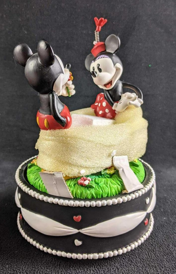 Disney Mickey & Minnie Love Music Box New: Disney Mickey & Minnie Love Music Box New This is an adorable music box with Mickey giving Minnie flowers. This is in like-new condition with all its original packaging and protective packaging. The m