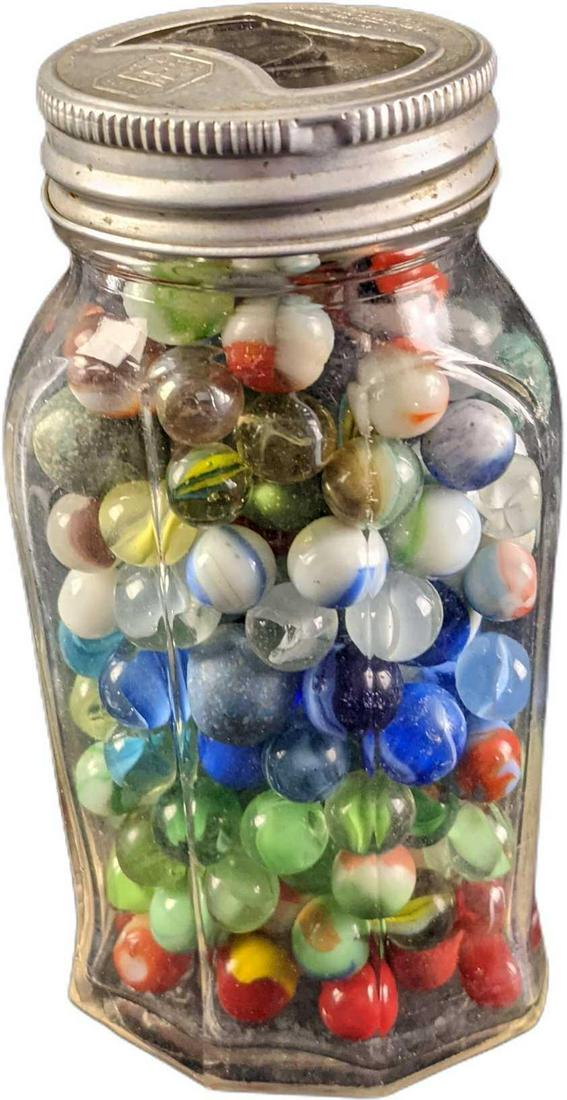 Capstan Glass Company Jar Of Vintage Marbles: This lot includes around 75-100 vintage marbles inside an Capstan Glass Company jar. The jar itself was made in 1934-1937. The marbles range in size and color. Please see the images as they are part o