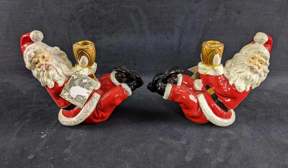 Christmas Santa Candle Holders: Christmas Santa Candle Holders This is a set of Santa candle holders. These Santa candleholders are in good condition with slight age wear with one Santa having paint crack on his face. Overall these 