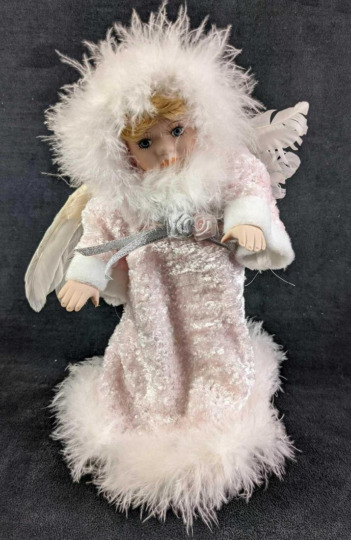 Animated Music Box Angel Porcelain Doll: Animated Music Box Angel Porcelain Doll. The music box plays Amazing Grace while the doll's arms move back and forth along with its body. Comes with a stand, Maker, and date of creation is unknown. Do