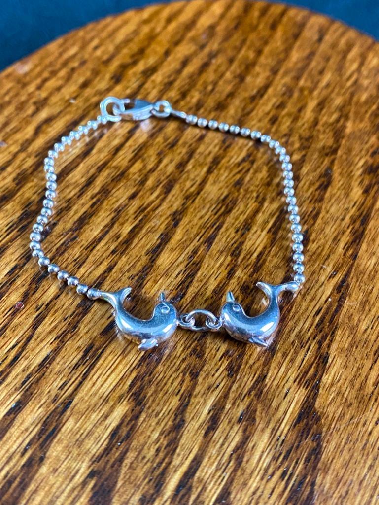 Dolphin Charm Bracelet: Dolphin Charm Bracelet This piece of authentic fine jewelry as been tested and researched prior to listing . Please view all our pictures they are part of our description. DETAILS: Metal - .925 Silver