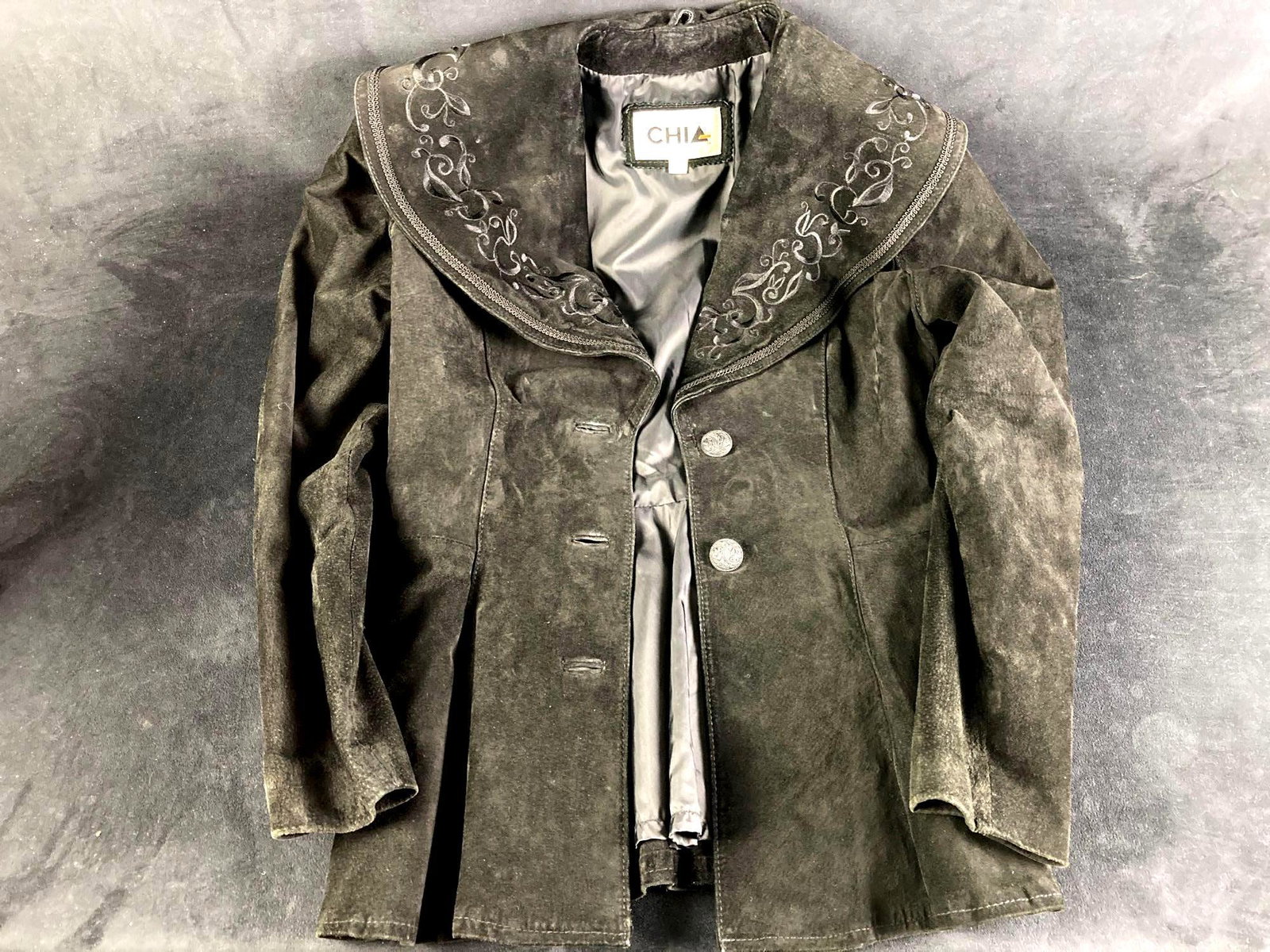 Black Chia Coat 80's Vintage: Up for auction is one black Chia coat with buttons adorning the front. Fresh from a recent estate and circa 1980's. This auction includes: (1) Black Chia Coat Condition is used with no odors or tears 