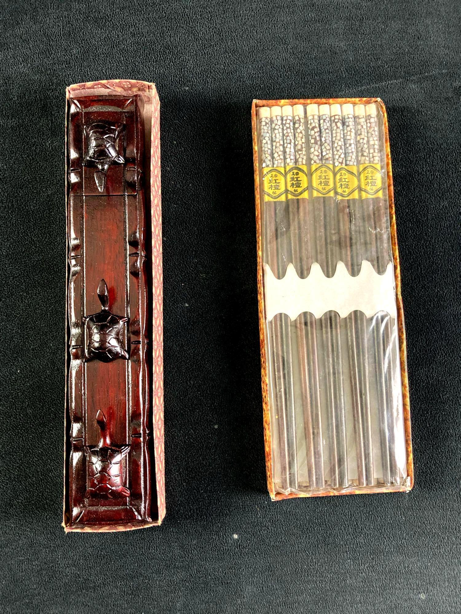 Set of (2) Packs of Chopsticks: This auction includes: (1) Vietnamese Chopsticks (1) Box of Turtle Chopsticks Hand Carved Fine Wood Case with three turtles and 5 sets of gold-lettered chopsticks inside and an extra 10 set of wooden 
