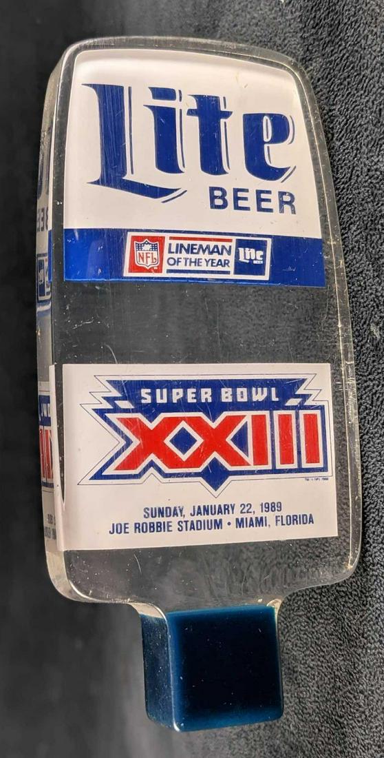 1989 Miller LITE BEER Super Bowl XXIII Football Acrylic Beer Tap Handle: 1989 Miller LITE BEER Super Bowl XXIII Football Acrylic Beer Tap Handle. Is approx 3" x 1" x 6 1/4" and weighs under one pound at 0.51lb. Made of acyclic. Is in a good, used condition with light wear