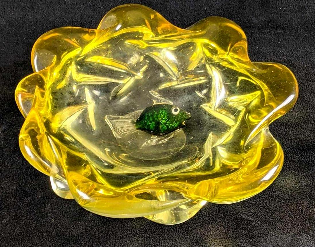 Yellow Glass Art Bowl with Fish Design: Yellow Glass Art Bowl with Fish Design This bowl is a glass art decorative bowl that has a glass fish swimming around inside of it. This is in good condition with some scratches on the bottom where it