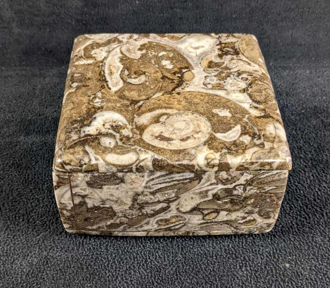 Marble Fossil Trinket Box: Marble Fossil Trinket Box This is a charming square-shaped trinket box made from marble with impression fossils. The box is polished with a lid. This trinket box is in good condition with no known dam