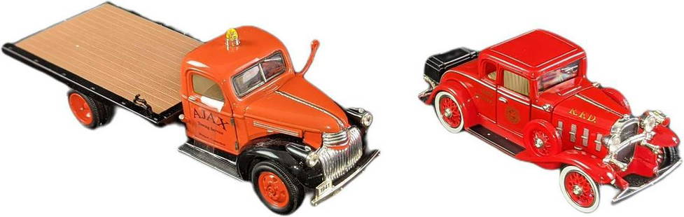 Ajax Flatbed Tow Truck & Fire Cheif 1932 Roadster Diecast Cars: (1) Ajax Flatbed Tow Truck. National Motor Museum Mint die-cast 1:32 scale model of 1941 Chevy flatbed truck with tie-down hooks. Doors/hood open. Comes in an box which is approx 9" x 3" x 3 1/2". (1)