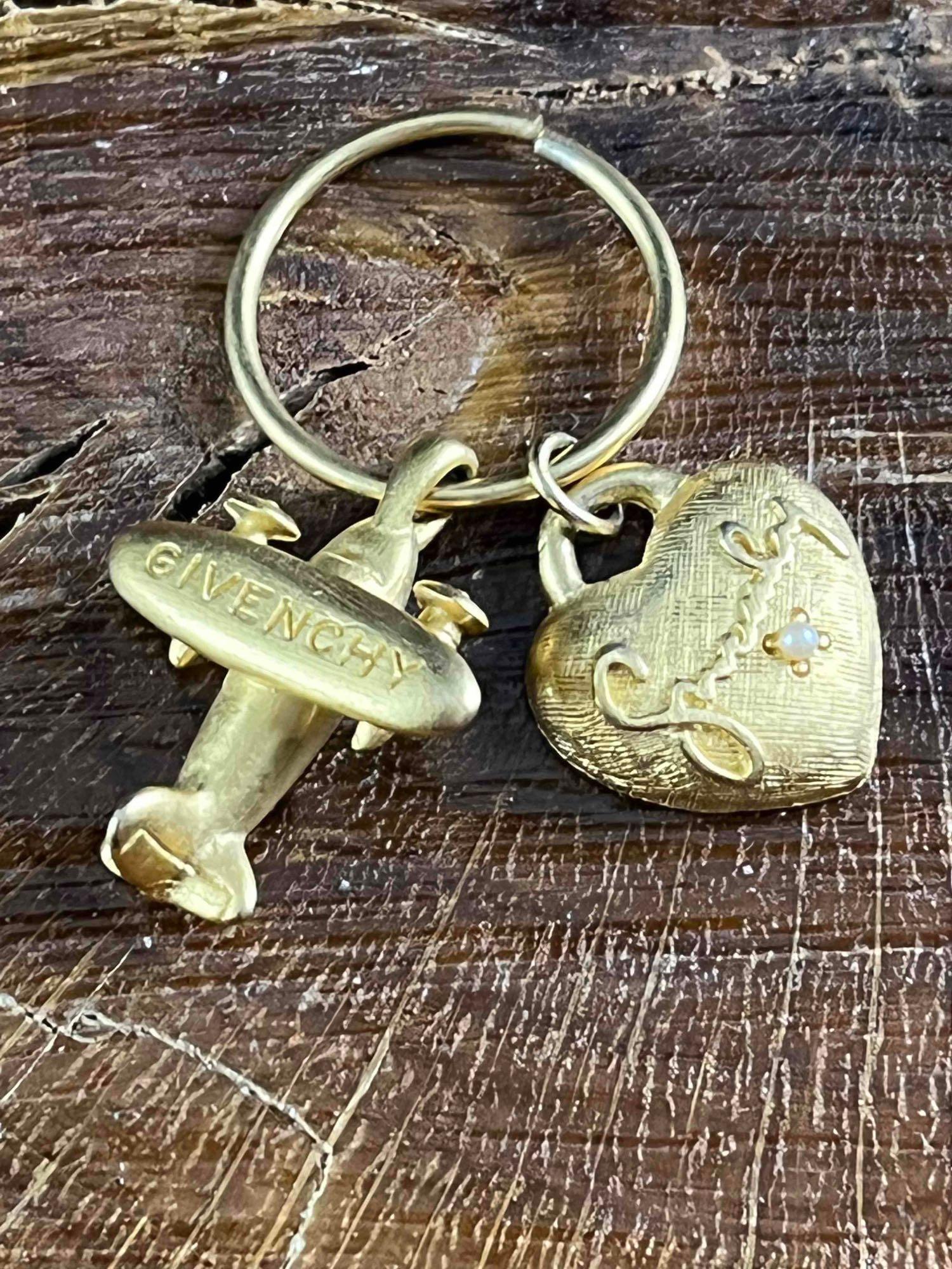 Vintage Givenchy Charms: Vintage Givenchy Charms Pictured is a plane and heart on a loop made by the designer brand Givenchy. These charmed are from their fashion jewelry line as they were part of an earring set. The plane ha