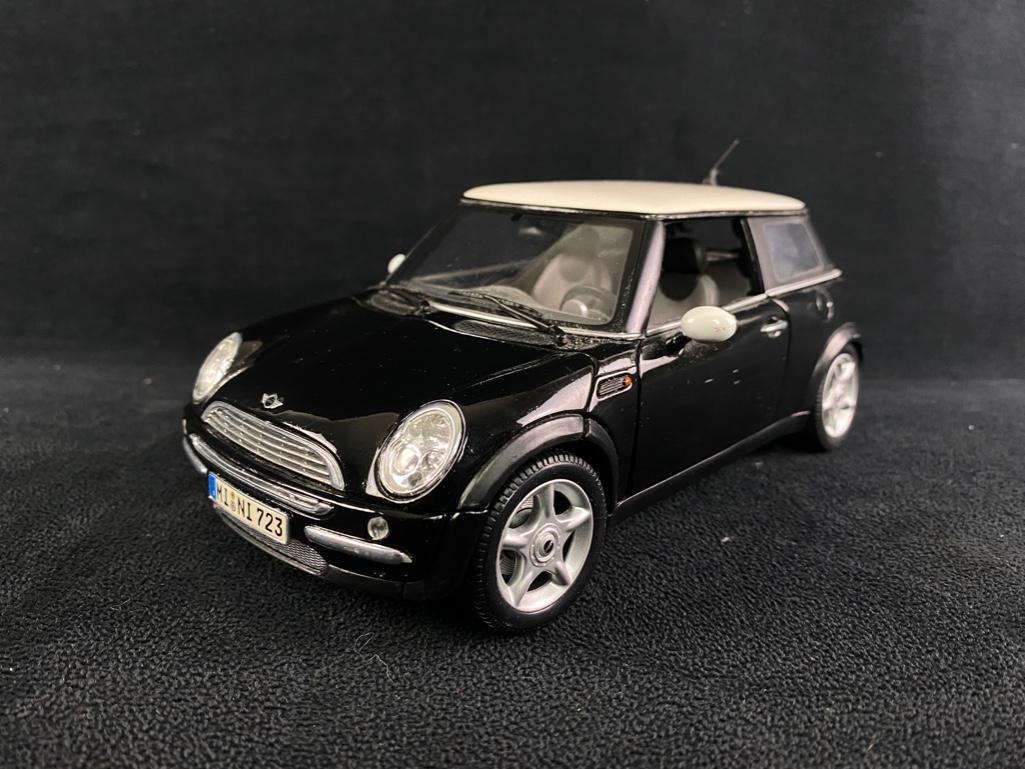 Black Maisto Mini Cooper 1:18 Scale Model Car: Black Maisto Mini Cooper 1:18 Scale Model Car This Maisto Mini Cooper features incredible detail, with a working steering wheel, and opening doors, trunk, and hood. In good condition with no known dam