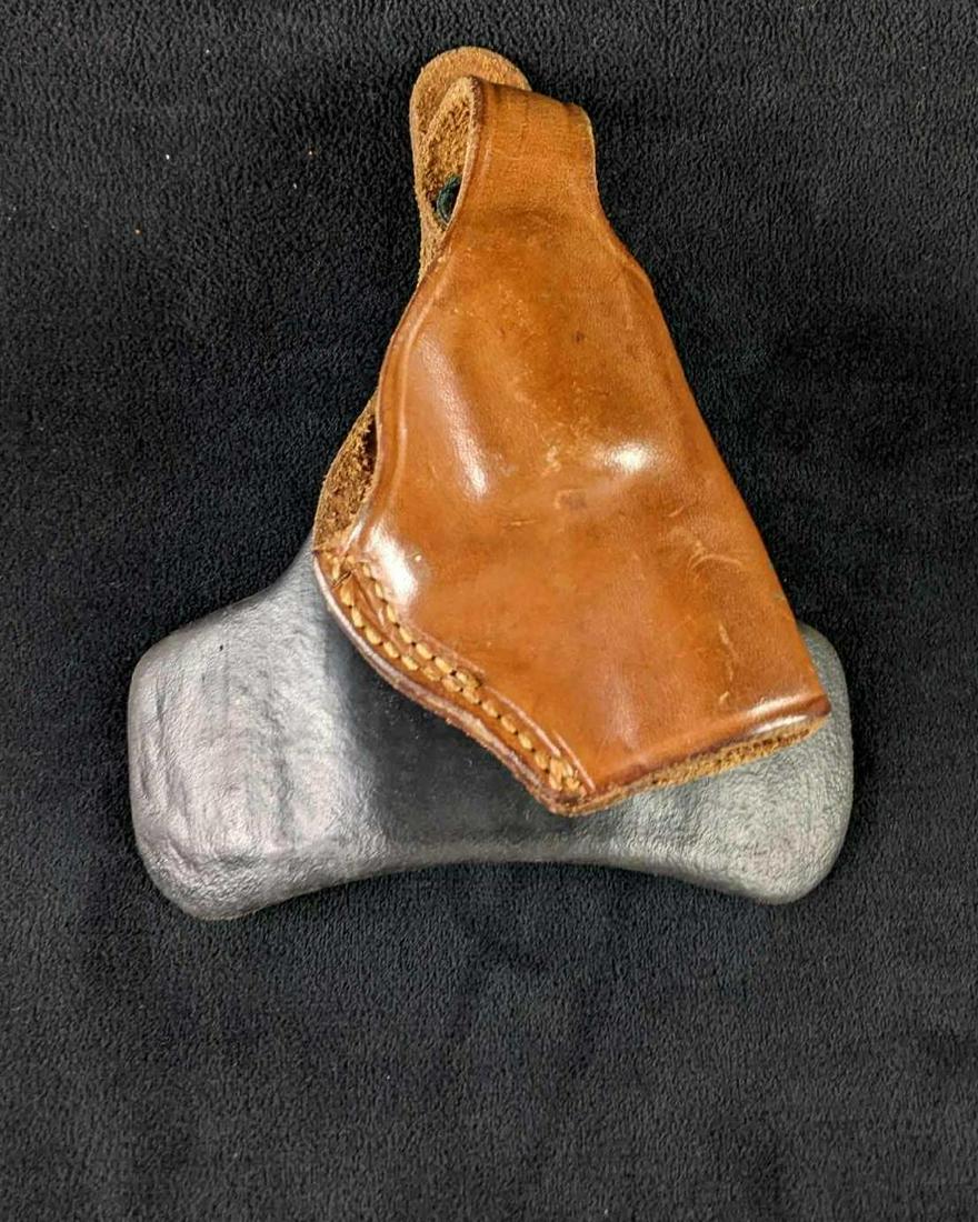 Brown Leather Holster S & W Holster Revolver: Brown Leather Holster S & W Holster Revolver This is a genuine leather holster for a revolver. It comes with a piece that tucks into the waistband to carry the holster with. This item is in good condi