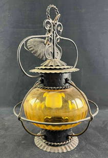 Vintage Amber Glass Globe Lamp: Vintage Amber Glass Globe Lamp This vintage lamp ias made from beautiful amber glass encased in metal. This is made bas a ceiling lamp and has a small part on top to hang and connect wiring. The lamp