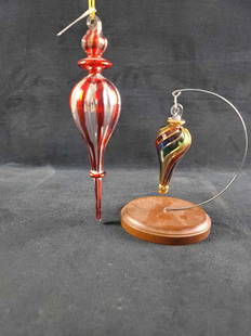 Blown Glass Finial Peppermint and Rainbow Ornaments: This lot contains: 1- Raz Imports, Made in China, Peppermint design Finial glass ornament, with tag. Approx. measures 2" x 8" x 11" hang, weight is .09 lbs 1-Unbranded, Rainbow Finial glass ornament.