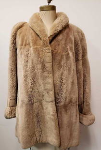 Pellicce Canali Karakul Coat: Pellicce Canali Karakul Coat. This coat is in great used condition. The coat has no known damages to the interior or exterior of the coat. The coat has a light brown fabric interior lining with two