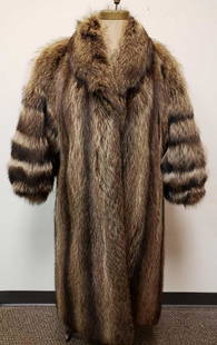 Full Length Raccoon Fur Coat: Full Length Raccoon Fur Coat. This fur coat is in great used condition. The coat has no known signs of damage on the interior or exterior. The coat has a light brown interior fabric lining. The coat