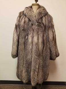 Gray Raccoon Dog Coat by Marpel 2 Torino: This fine 3/4 length gray raccoon dog coat by Marpel 2 Torino is in great condition with no known damages. Dark brown fabric interior. 3 hook and loops for closure; 2 outside concealed pockets.