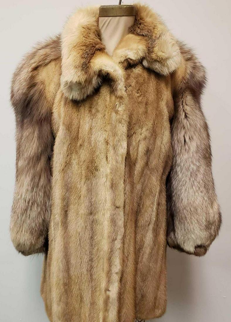 Olivier Fox and Mink Fur Coat: Olivier Fox and Mink Fur Coat. This fur coat is in great used condition. The coat has no known damage to the interior or exterior. The coat has a mink body/cuffs with a fox fur collar and sleeves. The