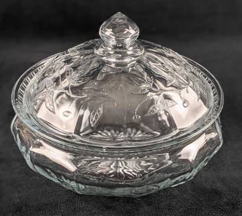 Covered Glass Bowl With Floral Design: Glass bowl with lid. Has a lovely floral design on the lid and a starburst design on the bottom. The maker and date of creation are unknown. Bowl is approx 8" x 8" x 7 1/2". Bowl is in good, used