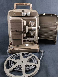 1950 Projector Film Bell and Howell 8mm 253A: 1950's Film Projector Bell and Howell 8mm 253A encased in a sturdy carrying case. The handle on the exterior case has some wear from being handled throughout the years. Sturdy construction.Dimensions