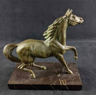 Metal Horse Statue On Black Marble Base: Metal Horse Statue On Black Marble Base This is a metal horse statue a painted on green patina. The statue is mounted on a marble base. This piece is in good condition with only small scratches and