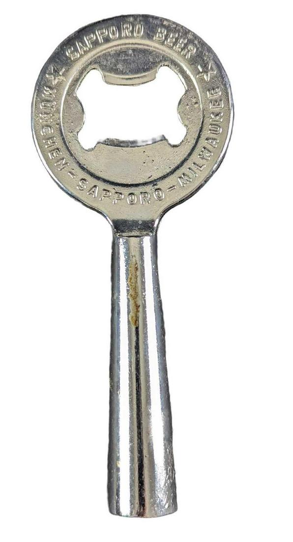 Vintage Metal Sapporo Beer Bottle Opener: Vintage Metal Sapporo Beer Bottle Opener. Made in Japan. The opener is approx 2 3/8" x 3/4" x 5 3/4" and it weighs 0.21lb. The opener is in a good, vintage condition with some signs of wear and some m